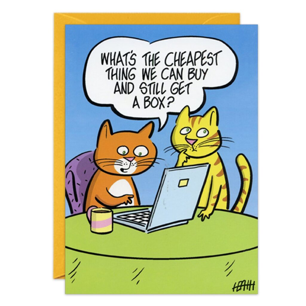 Cartoon of two Box Cats with a laptop at a table, asking, "What's the cheapest thing we can buy and still get a box?" A glass and yellow envelope are seen. Perfect as a Box Cats Birthday Card! Product Name: 8964.jpg.