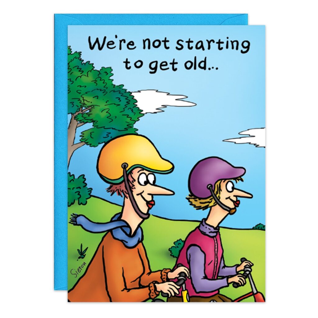 Cartoon from "9027.jpg" shows two older adults smiling on a tandem bike outdoors, both wearing helmets. Above them: “We’re not starting to get old…” Ideal Biking Birthday Card with trees and blue sky in the background.