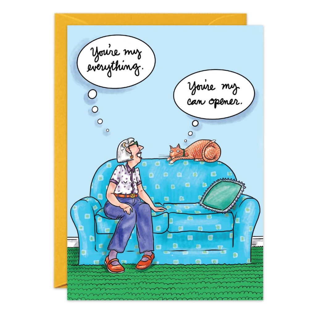 An older woman on a blue couch gazes at her orange cat. She thinks, "You're my everything." The cat, lying nearby, thinks, "You're my can opener." A purr-fect 9089.jpg birthday card moment!.