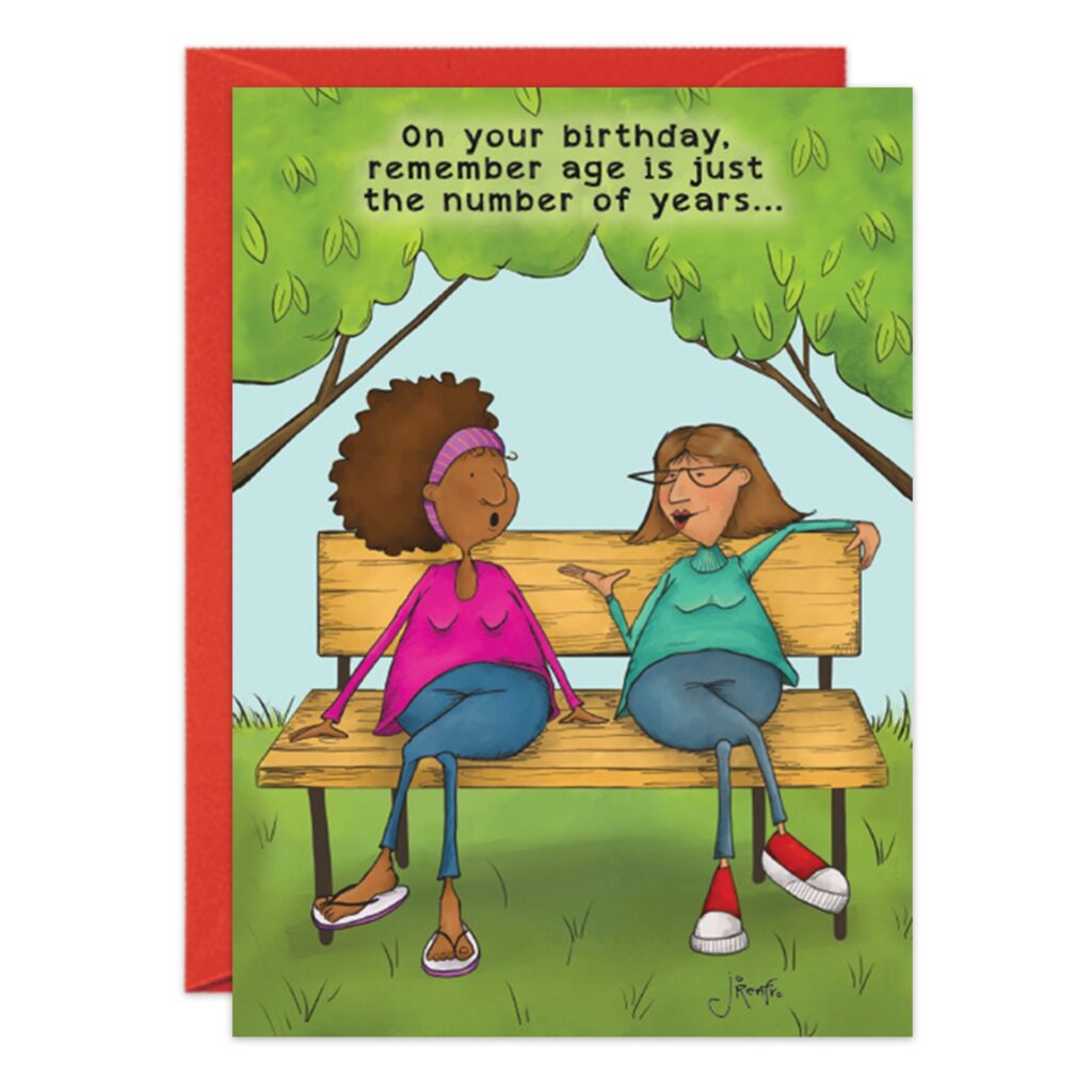 Two women, smiling and relaxed, sit chatting on a park bench under the trees on the "9118.jpg" Park Bench Birthday Card, which reads: “On your birthday, remember age is just the number of years…” Both are casually dressed.