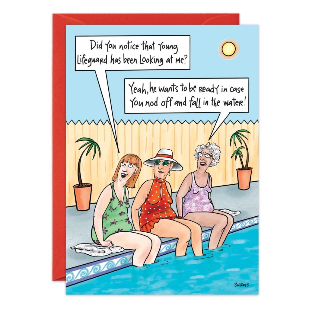 Three older women in swimsuits sit by a pool, smiling. One asks if the young lifeguard is looking at her. Another jokes, "Maybe it’s your 9257.jpg birthday card moment—he’s just making sure you stay afloat!.
