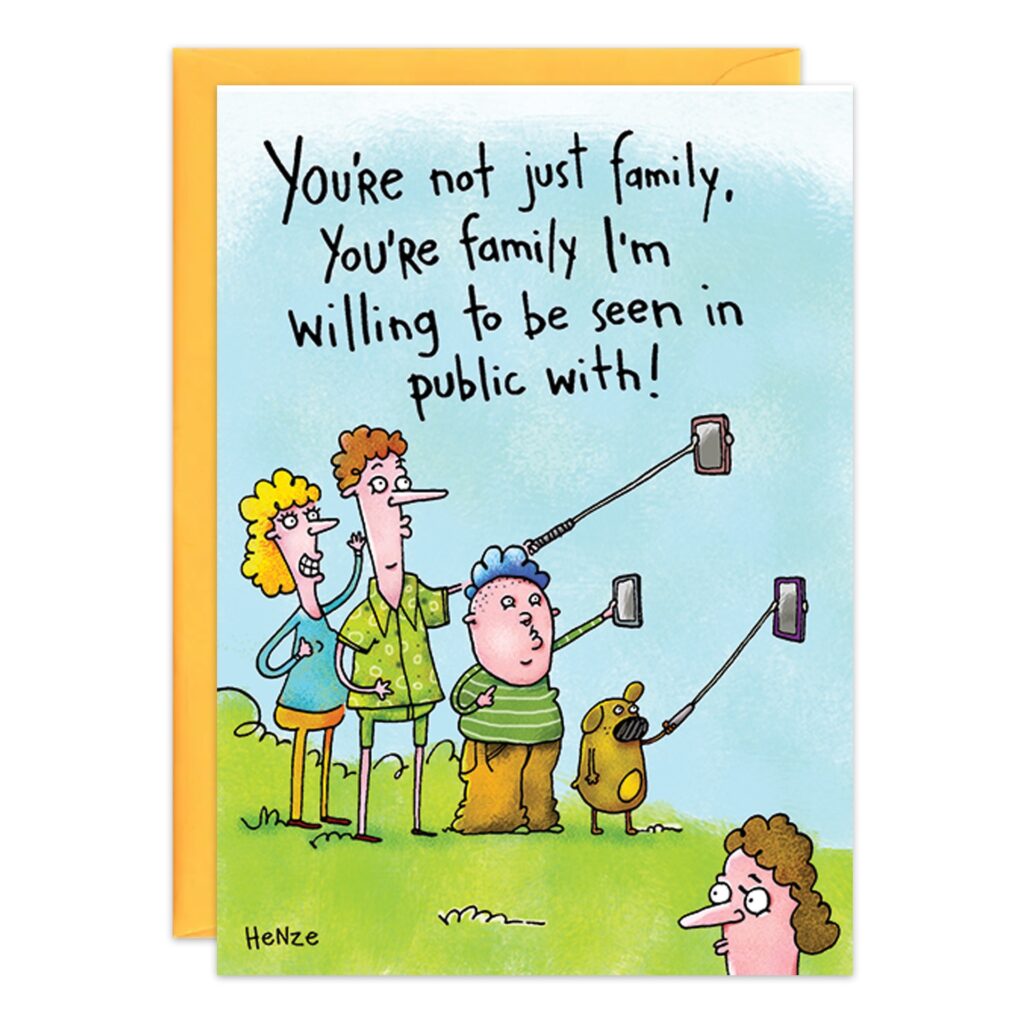 A fun birthday card featuring a cartoon of three people and a dog taking selfies, with another person watching in the foreground. Text: "You’re not just family, you’re family I’m willing to be seen in public with!.