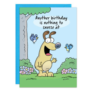 A cartoon dog stands in grass, smiling with one paw up, next to two blue birds, flowers, and a tree. The card (9469) reads "Another birthday is nothing to sneeze at." A blue envelope sits behind the card.